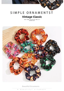 Set of 9 Halloween themed satin hair scrunchies with pumpkin, bat and skull patterns