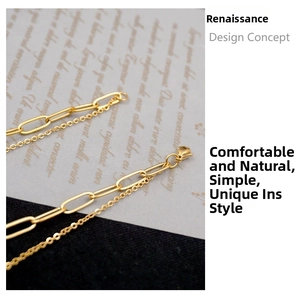 Detail of gold double-layered paperclip necklace with lobster clasp and metal texture