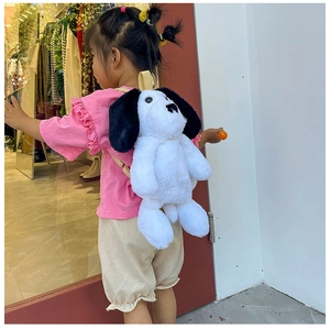 Detail view of Snoopy-style plush backpack with soft fur and yellow fabric straps