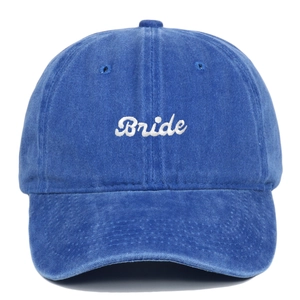 Close-up of white Bride embroidery on a washed blue cotton vintage baseball cap