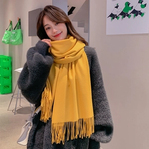 Soft yellow cashmere-feel scarf with elegant fringe detail for winter warmth