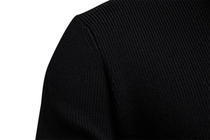 Macro detail of high-quality black knit shoulder stitching and ribbed fabric texture