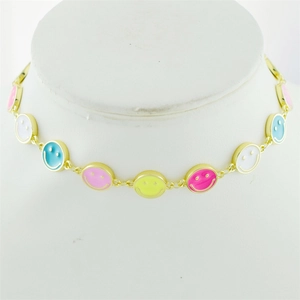 Detail of gold-plated necklace featuring vibrant colorful smiley face enamel pendants