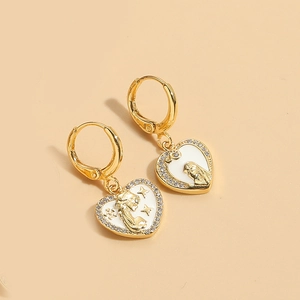Detail of heart-shaped gold earring with white enamel, zircon inlay and star relief