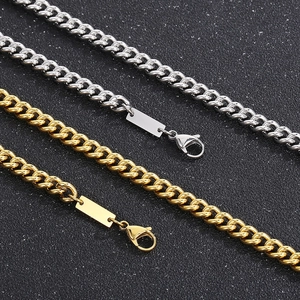 Close-up of gold and silver stainless steel Cuban link chains with lobster clasps