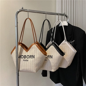 French retro woven straw bucket bag with leather straps in brown, black and white