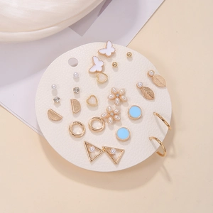 Detailed set of 12 gold floral and geometric stud earrings with pearls and crystals