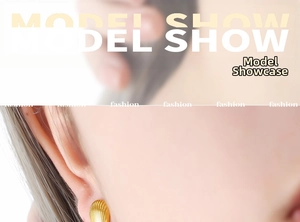 Detail of 18K gold titanium steel shell texture earring on model's earlobe