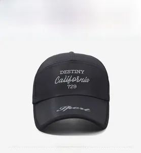 Close-up of black mesh baseball cap featuring white Destiny California embroidery