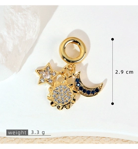 Macro shot of gold-plated celestial charms with zircon stars and moon detailing