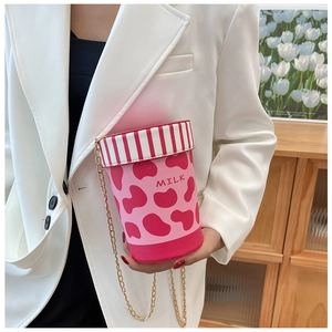 Chic pink milk cup shaped crossbody bag with cow pattern and golden chain strap detail