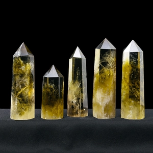 Natural Brazilian citrine crystal hexagonal prisms in various sizes on black background