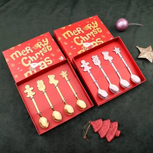 Detail of Christmas stainless steel spoons in gold and silver sets with cartoon icons