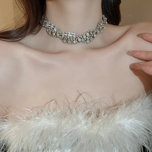 Close-up of a silver twisted choker necklace with sparkling rhinestones on a female model
