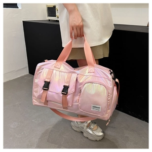 Close-up of pink iridescent travel bag with dual handles and detachable shoulder strap