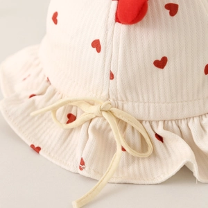 Infant heart print bucket hat with ruffled brim and adjustable chin strap details