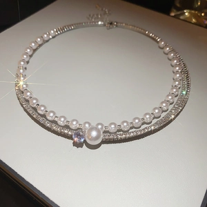Detail of elegant double-layered choker with sparkling rhinestones and white pearls