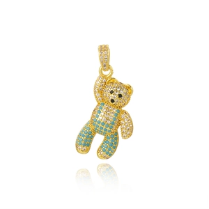 Macro shot of gold panda pendant encrusted with clear and turquoise crystals with reflection