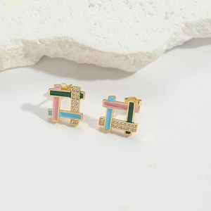 Close-up of square gold earrings with pink, blue, and green enamel and sparkling zircons