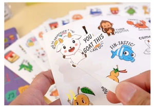 Close-up of hand using tweezers to peel a cute animal reward sticker with puns