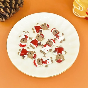 Flat lay of colorful resin Christmas bear charms for DIY crafts and holiday decorations