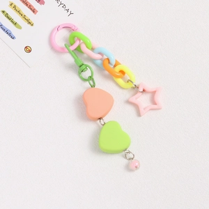 Close-up of colorful heart and star charms with mixed pastel plastic link chains