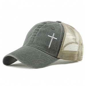Close-up of embroidered white cross on retro washed cotton and mesh trucker hat