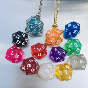 Close-up of colorful resin D20 dice in metal mesh pendant cages with chain necklaces