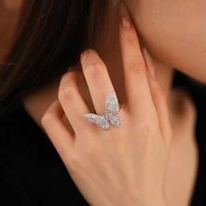 Elegant zircon butterfly open ring in silver finish worn by a model in soft lighting
