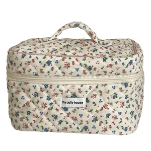 Quilted floral corduroy makeup bag with top handle and secure zipper closure