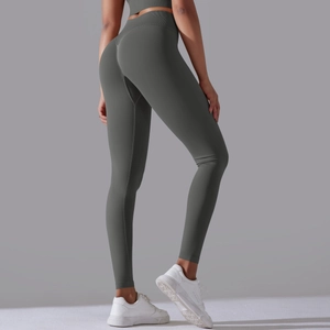 Detail of high-waist seamless yoga leggings showing lifting seams and matte dark grey fabric