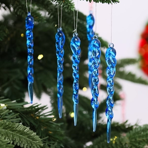 Detail shot of clear blue twisted icicle ornaments hanging on Christmas tree branches