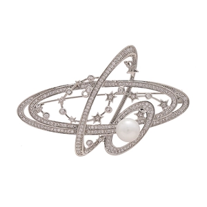 Metallic planet brooch with silver orbital ring, cubic zirconia, and central white pearl