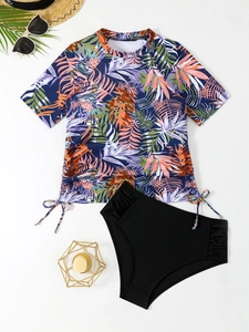 Close-up of tropical print tankini top with adjustable drawstrings and black bikini bottoms