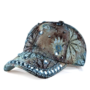 Detailed view of women's baseball cap with floral print and crystal rhinestones