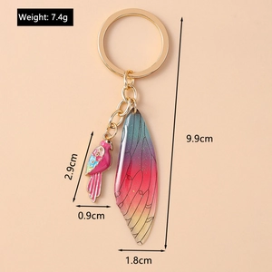 Detail view of bird and wing keychain dimensions showing 7.4g weight and 9.9cm length