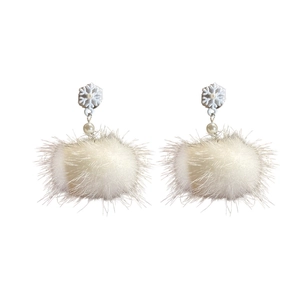 Winter snowflake pearl earrings with soft white plush pom pom balls on a white background