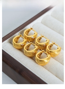 Detailed view of triple-layered U-shaped 18K gold plated titanium steel hoop earrings
