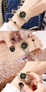 Close-up of Oruss two-tone steel watch with black dial and clover bracelet set