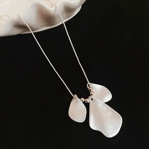 Minimalist silver snake chain necklace with white petal pendants and metallic silver beads