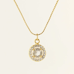 Macro detail of 18K gold-plated double-layer necklace with sparkling zircon pendant