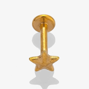 Detail view of a gold-tone star flat back stud piercing with green turquoise inlay