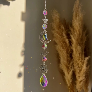 Detail of silver sun moon and star metal chains with sparkling crystal dreamcatcher prisms