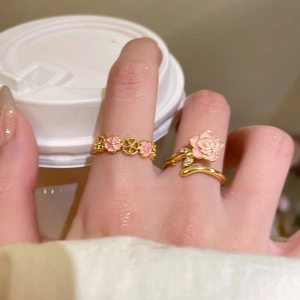 Detail of 18k gold plated floral ring set with pink enamel and sparkling zircon
