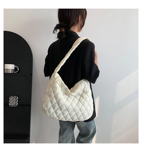Detail of white quilted puffer hobo bag showing its soft texture and large capacity size