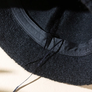 Macro shot of faux mink bucket hat interior with adjustable drawstring and sweatband
