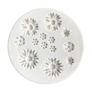White circular silicone mold with 13 diverse daisy and sunflower floral cavities for fondant