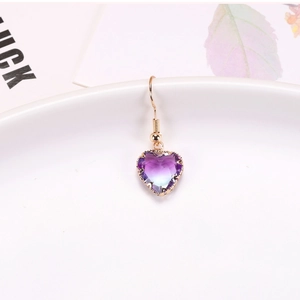 Detailed view of heart-shaped gradient purple crystal earrings with gold plated hooks