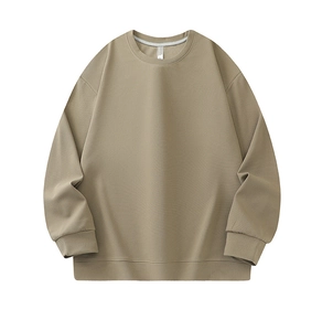 Detail of khaki crewneck sweatshirt showing jacquard knit texture and ribbed cuffs