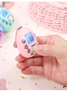 Detail of colorful rock paper scissors game keychains in pink, blue and purple tones